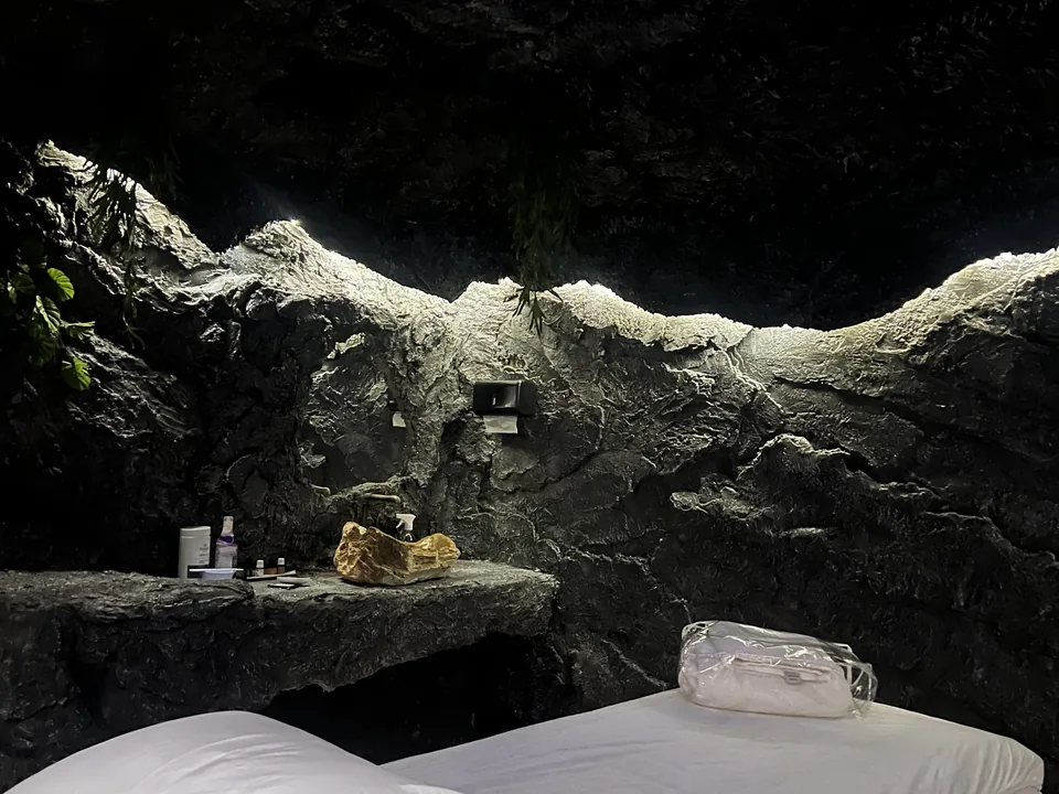 Maca de atendimento na Caverna Terapêutica, com parede de pedra iluminada